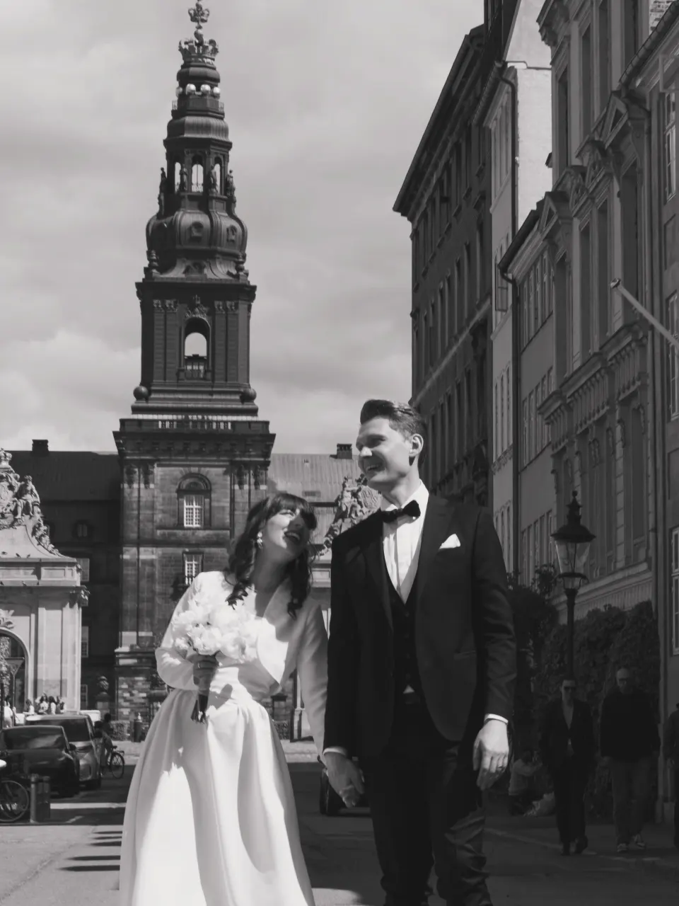 Newlywed couple portrait with Copenhagen church tower in the background
