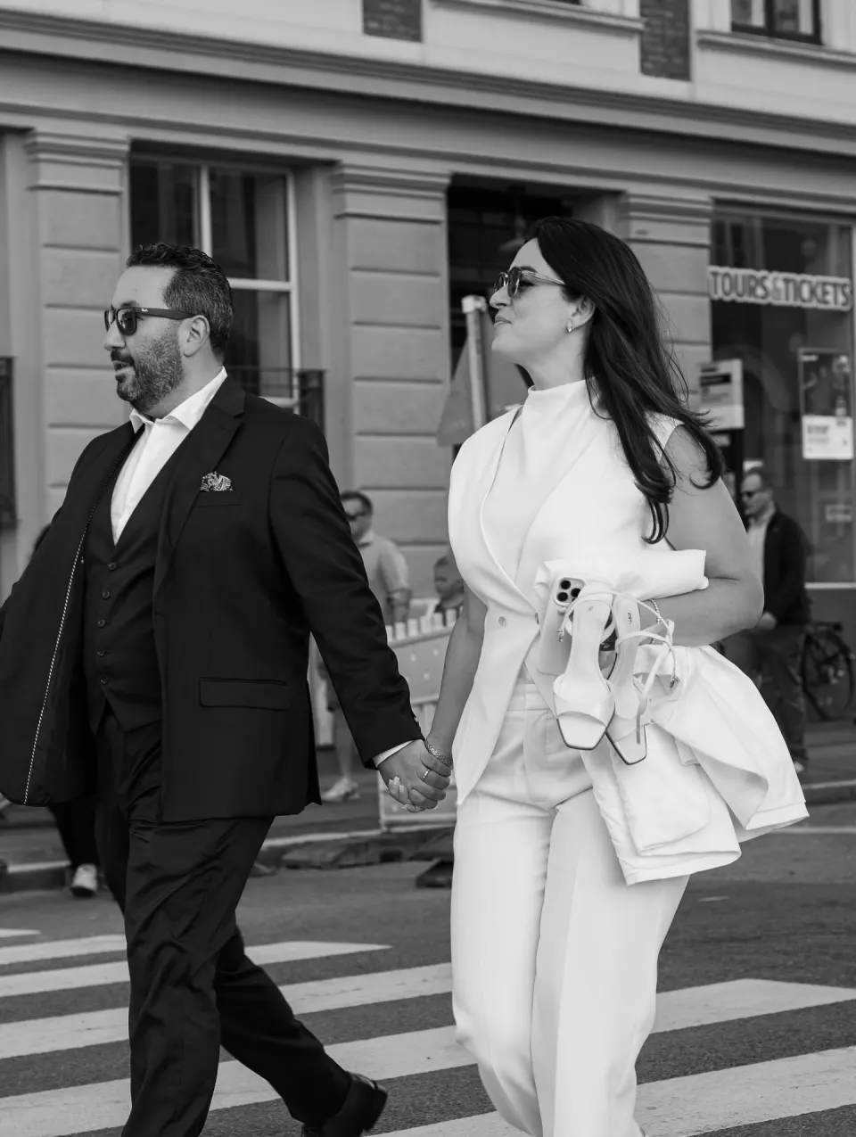 Couple walking hand in hand through Copenhagen streets after City Hall wedding