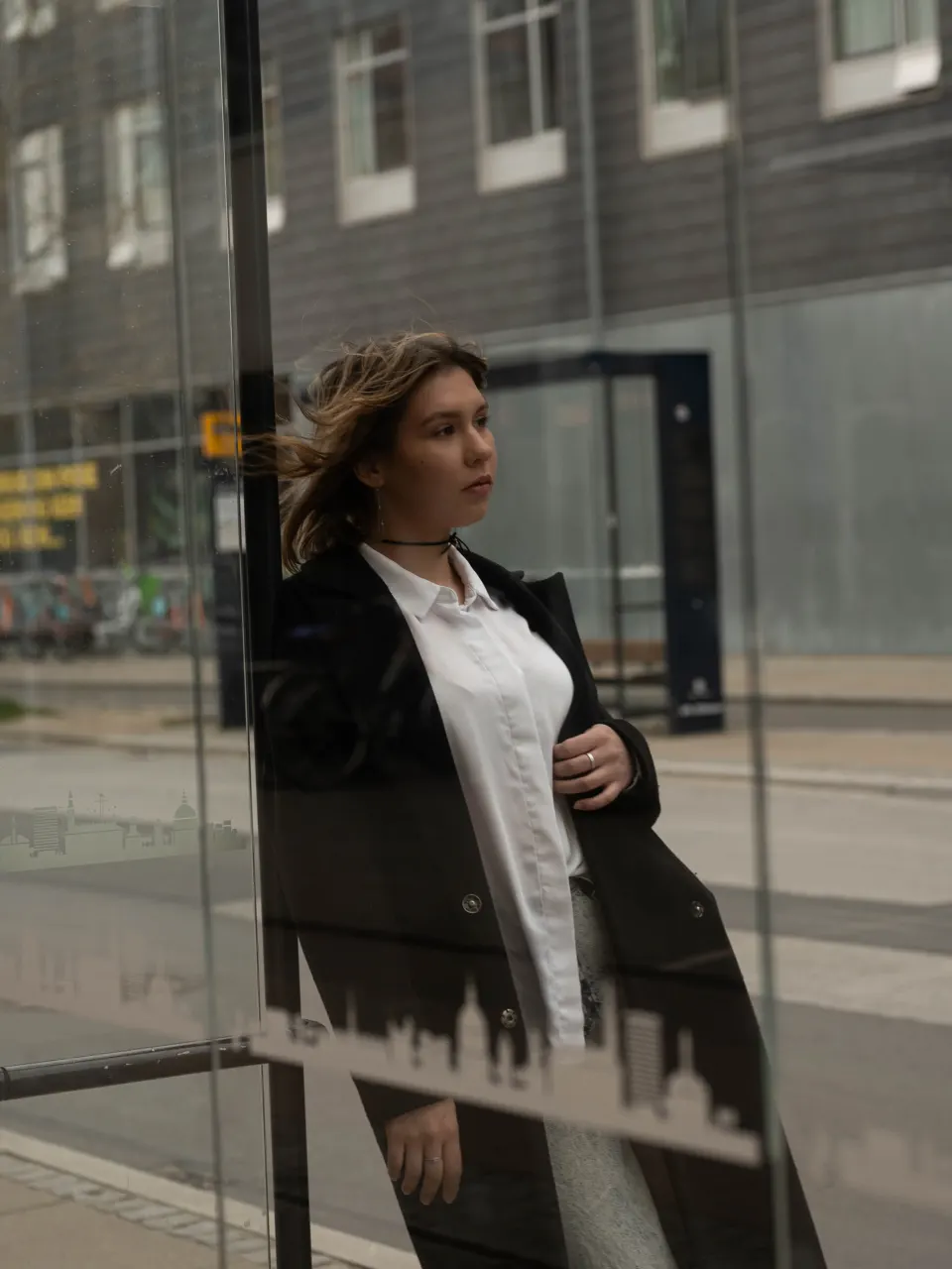 Portrait with reflections at a Copenhagen bus stop