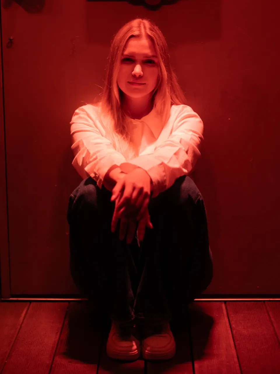 Creative studio portrait in red light