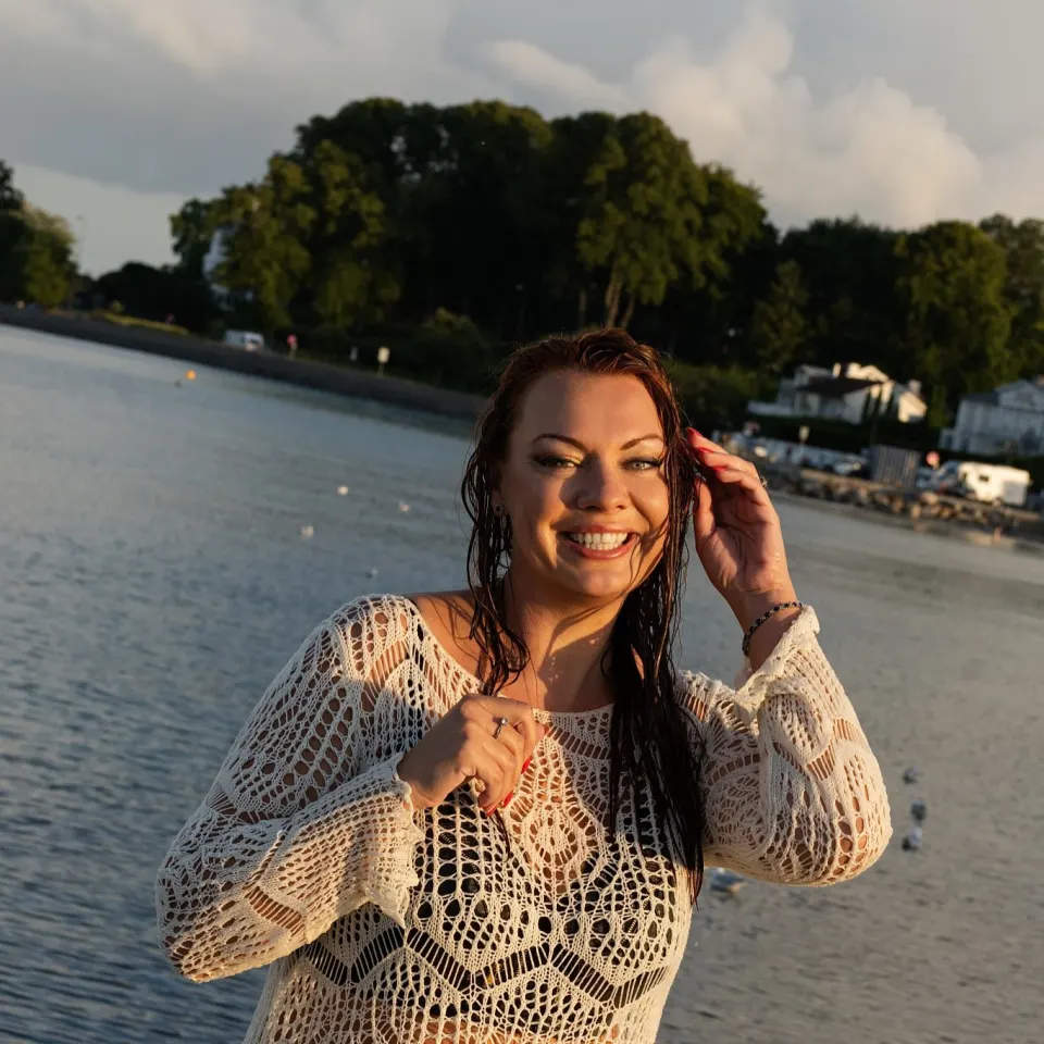 Sunset beach portrait of a smiling woman near Copenhagen