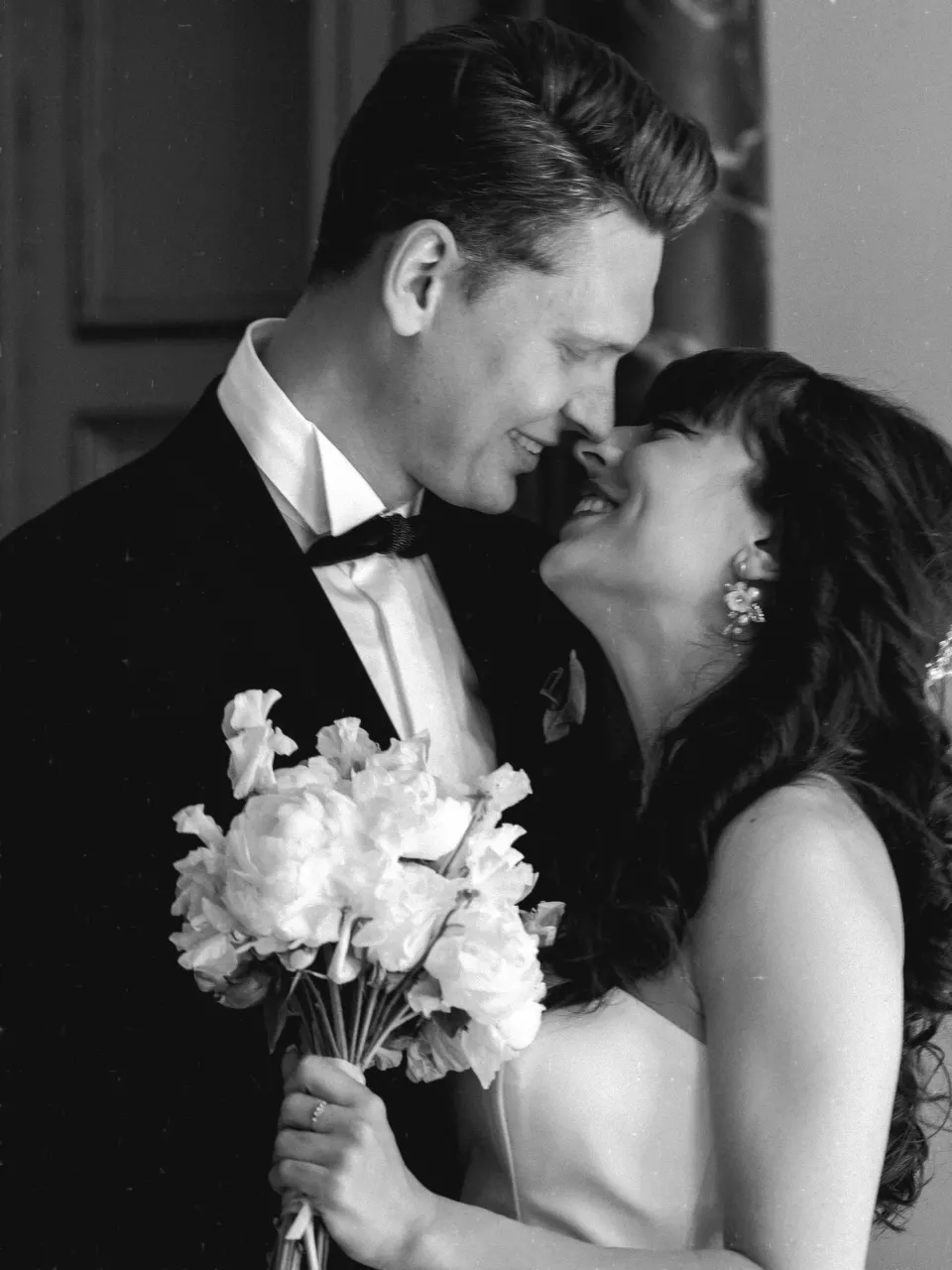 Laughing newlyweds with white peony bouquet, Copenhagen wedding photographer