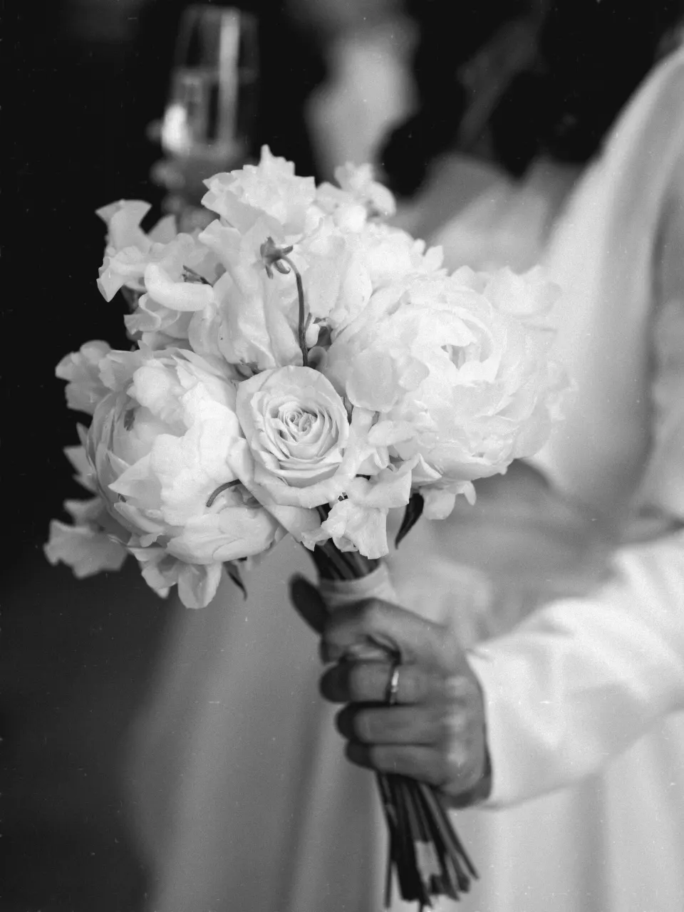Bride holding white rose and peony bouquet, wedding detail